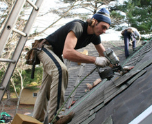 Roofer shingling a roof